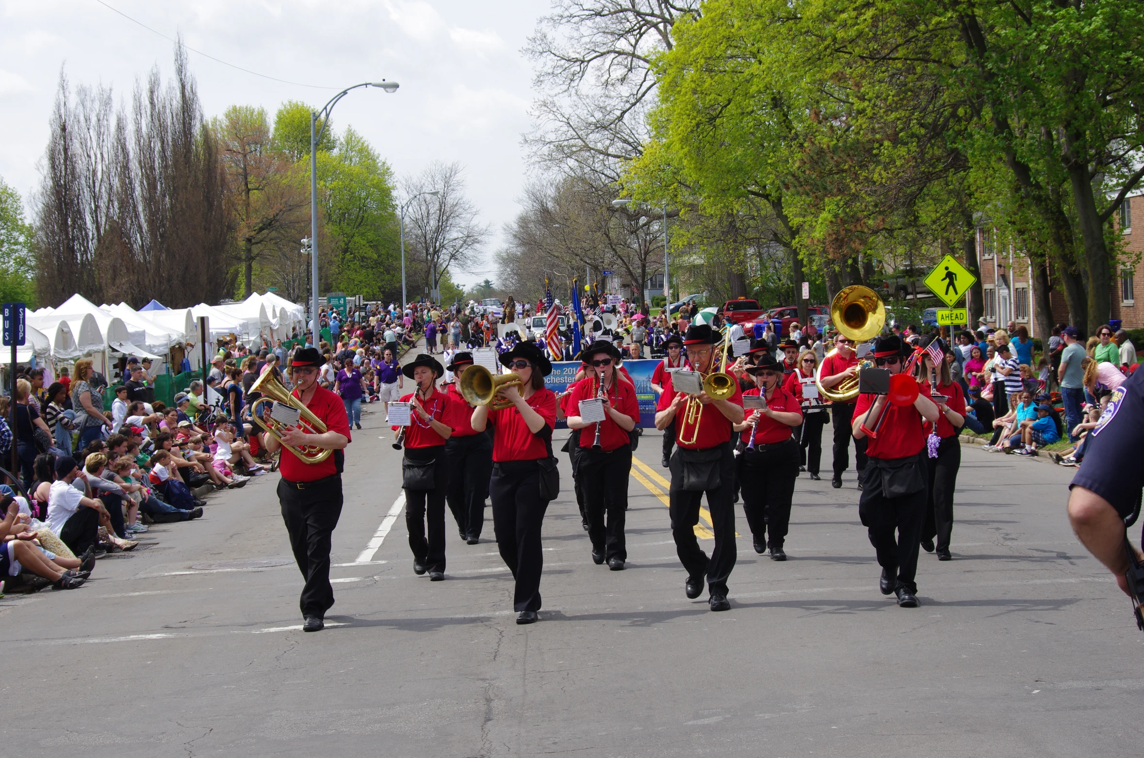 parade with marching band in middle of roadway