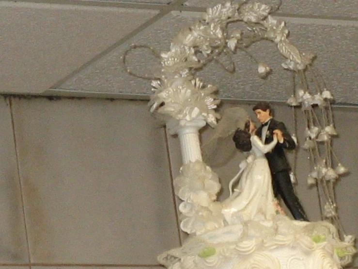 a cake topper is decorated with white frosting and flowers