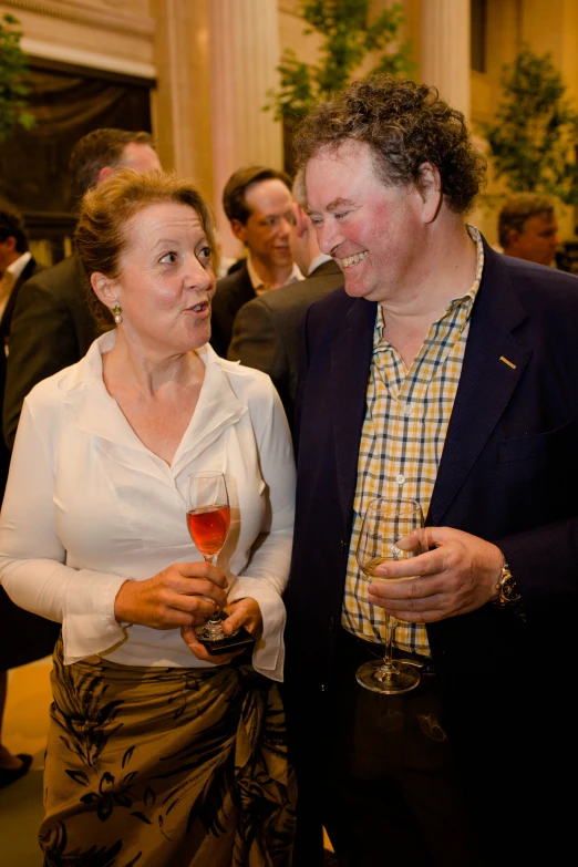 two people dressed in old - fashioned clothes drinking wine