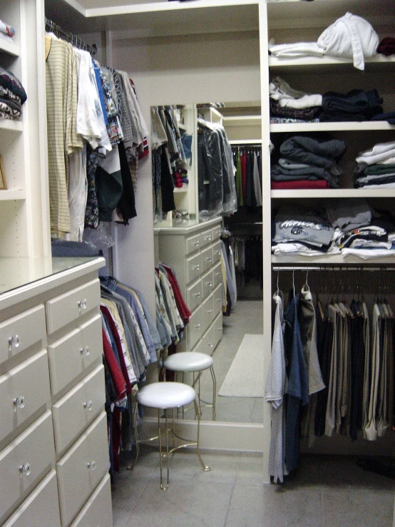 a closet filled with different shirts and clothes