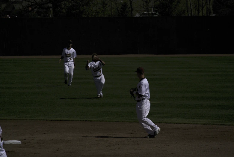 a group of baseball players running on the field