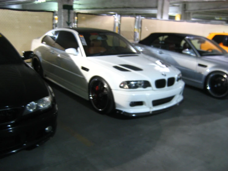 three cars parked side by side in an underground space