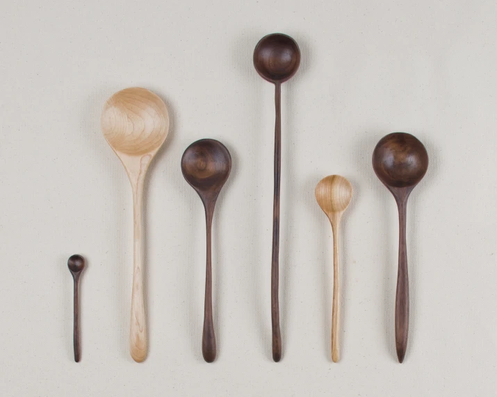 the seven spoons have different kinds of wooden handles