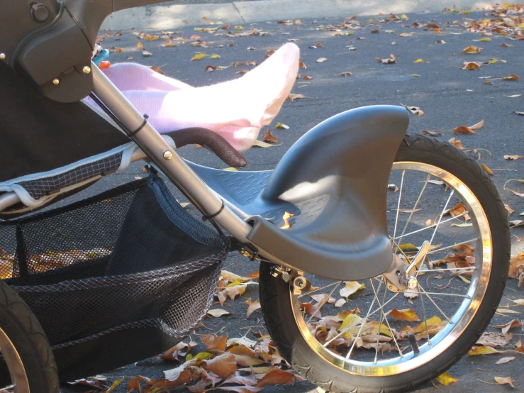 a very small child's bike parked next to a stroller