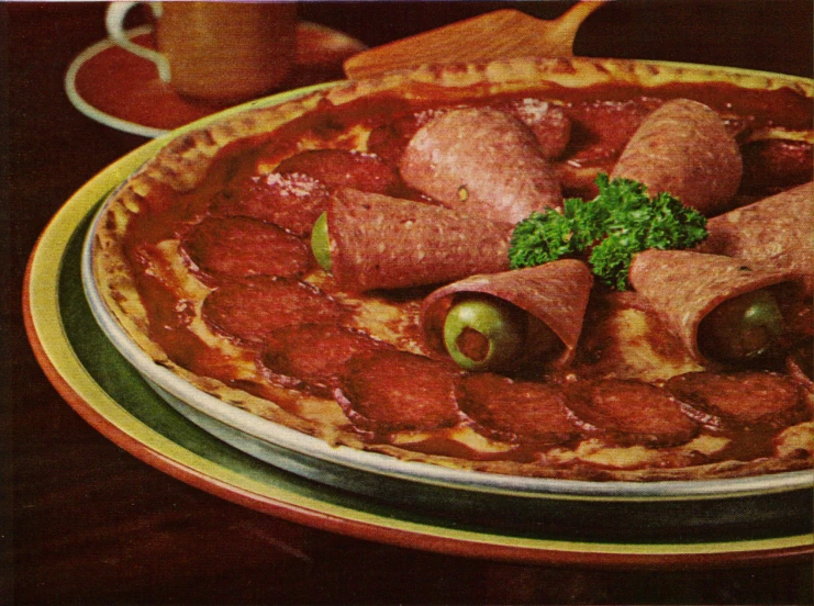 a close up of a pizza with sausage and tomatoes