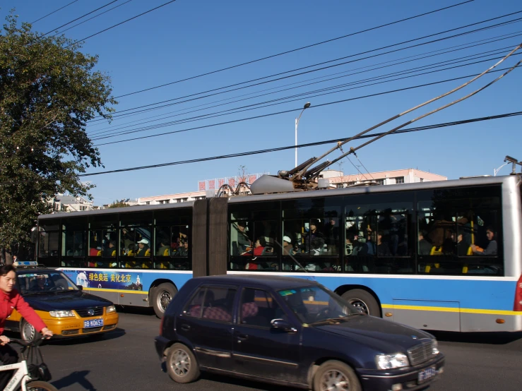 a couple of large cars driving down a street