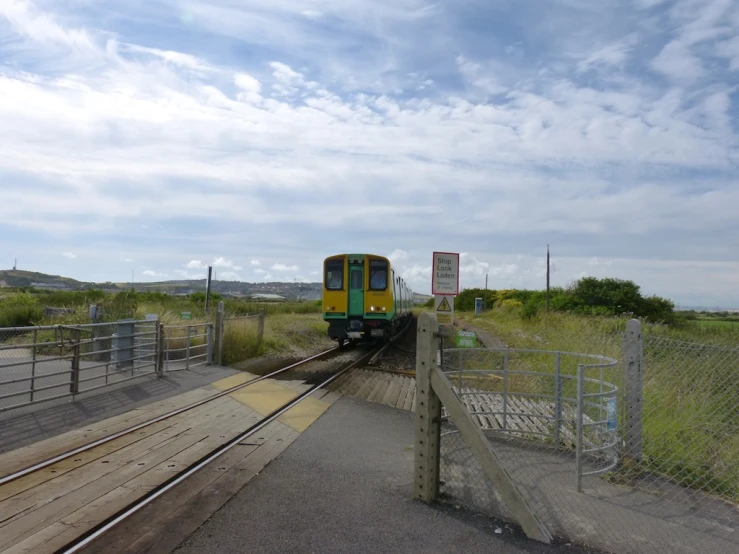 a train on the tracks near the grass