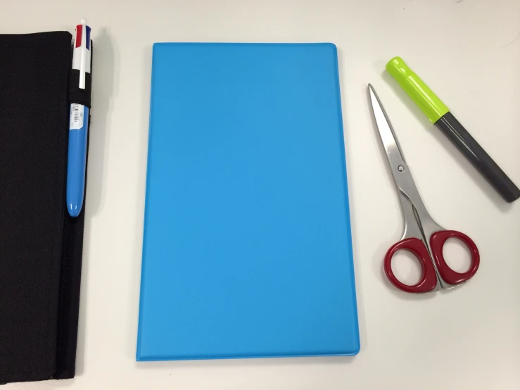 several scissors, a pen and a laptop case