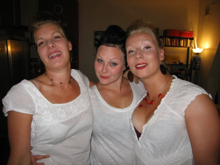 two young women and their mom posing for a picture