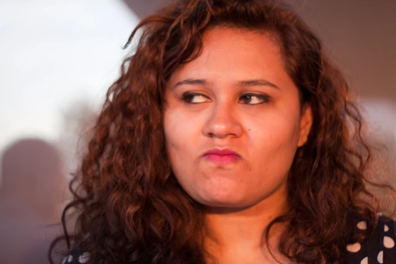 a woman with freckled hair has soing in her mouth