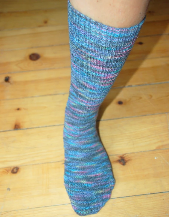the legs of a person wearing socks with their ankles down