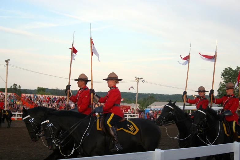 two men are riding horses with flags on them