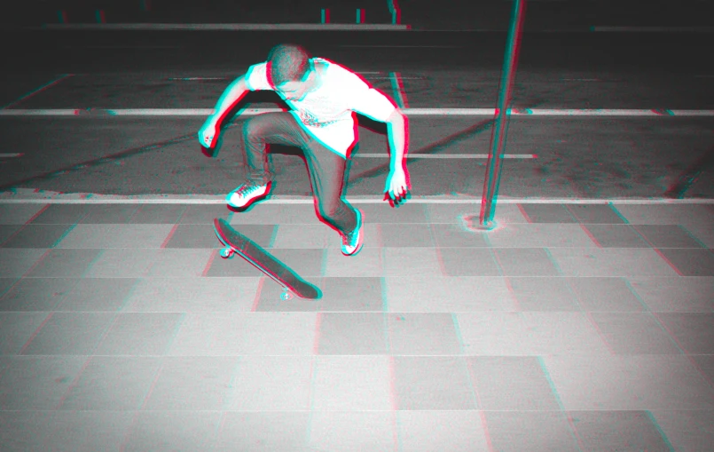 a person is riding a skateboard in the dark