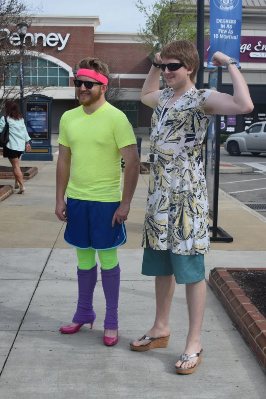 a man wearing colorful clothes is standing next to another man on the street