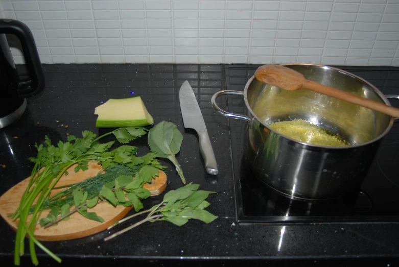 various vegetables and other herbs sit on the kitchen counter