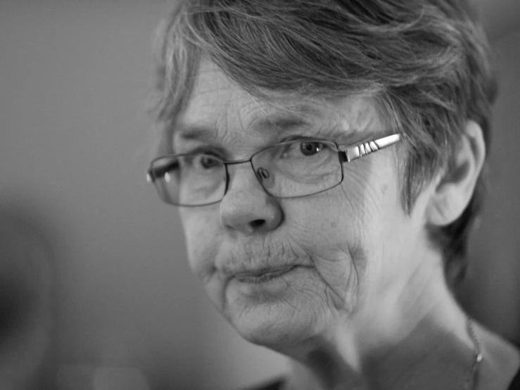 black and white image of an elderly woman with glasses