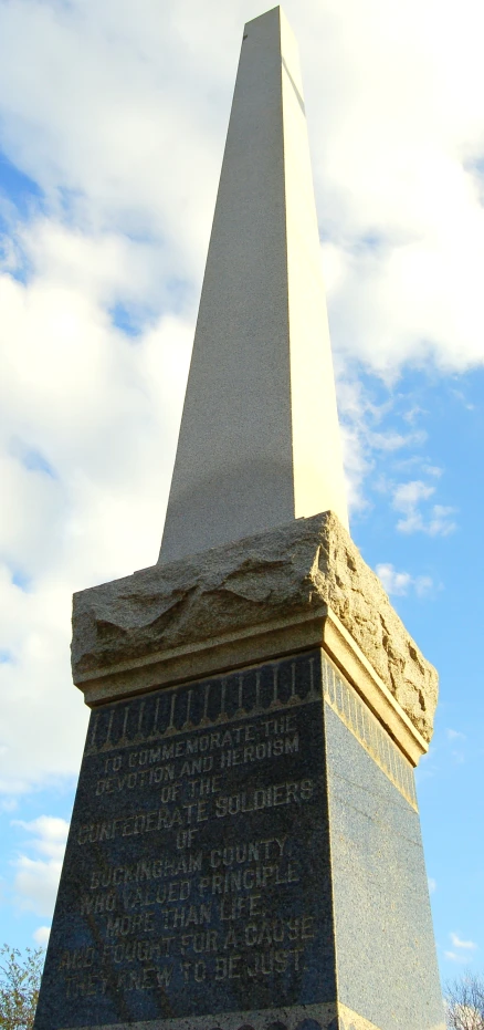 a tall obelisk on the edge of a stone block