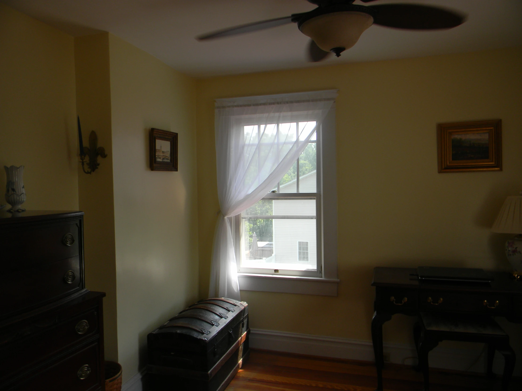 the window above the dresser looks out onto the street