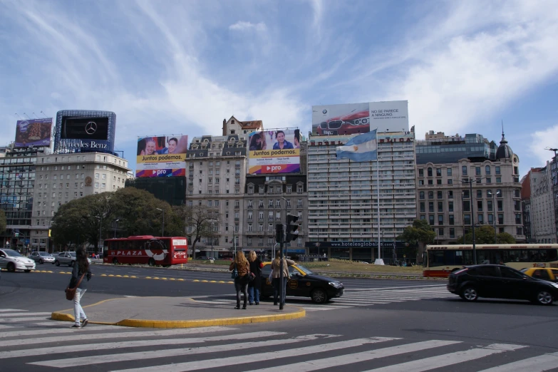 street scene with traffic, people and various advertits