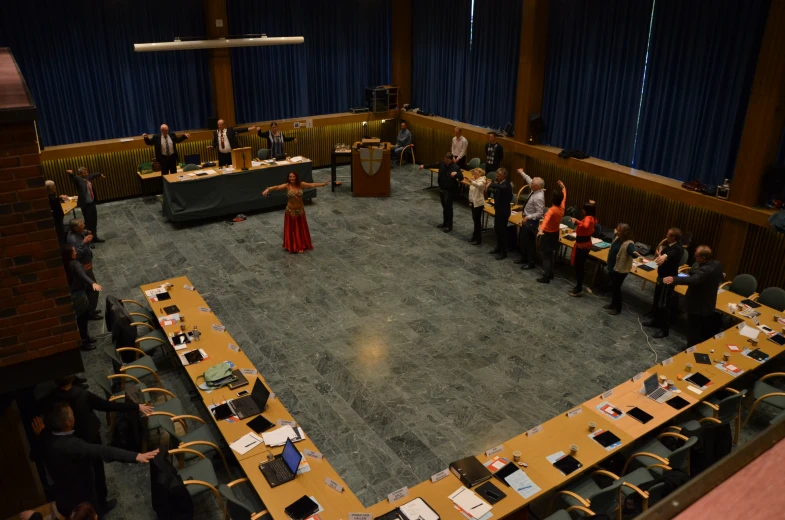 a group of people standing in front of long tables