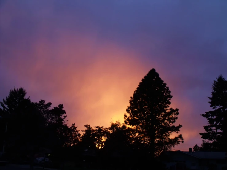 an orange and pink sunset shining in the sky