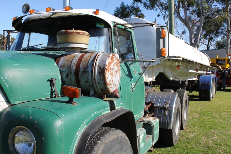 the old truck is parked by other cars