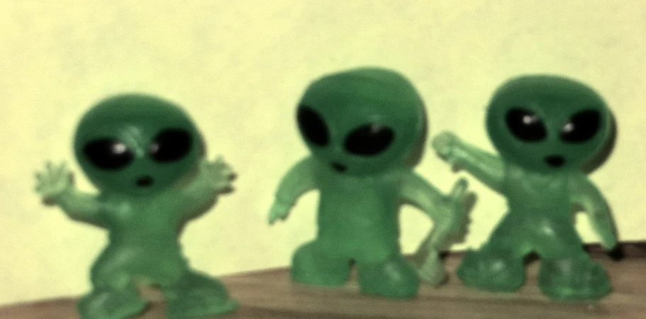 an array of alien statues with one waving