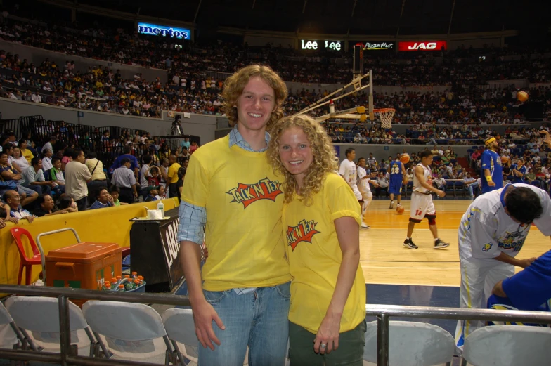 a man and woman are posing for the camera