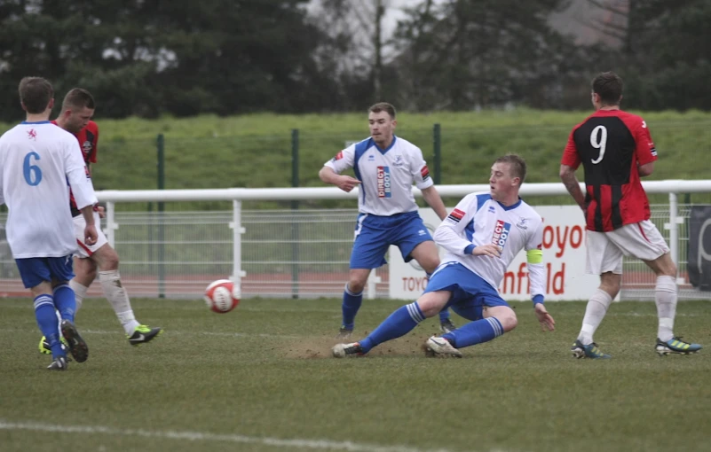 a soccer team going after the ball on a field