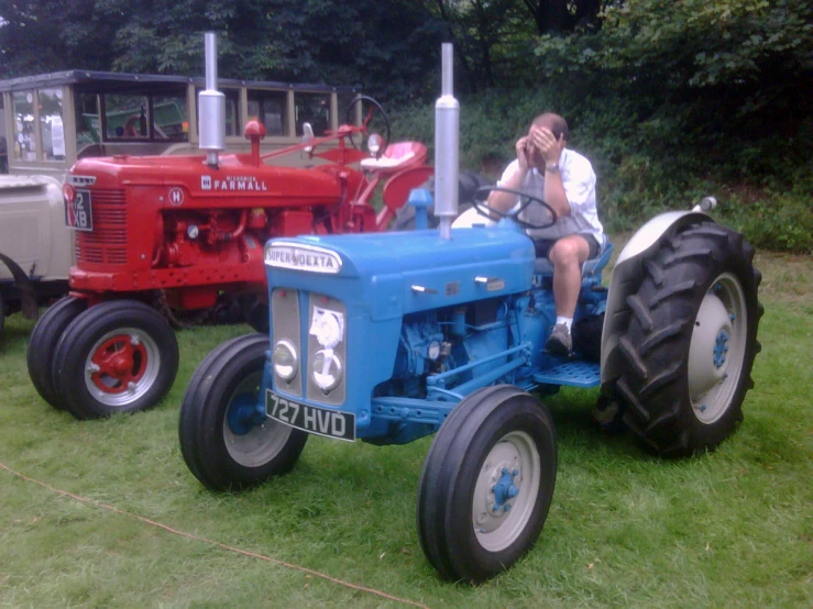 a man is on the phone while sitting in a tractor