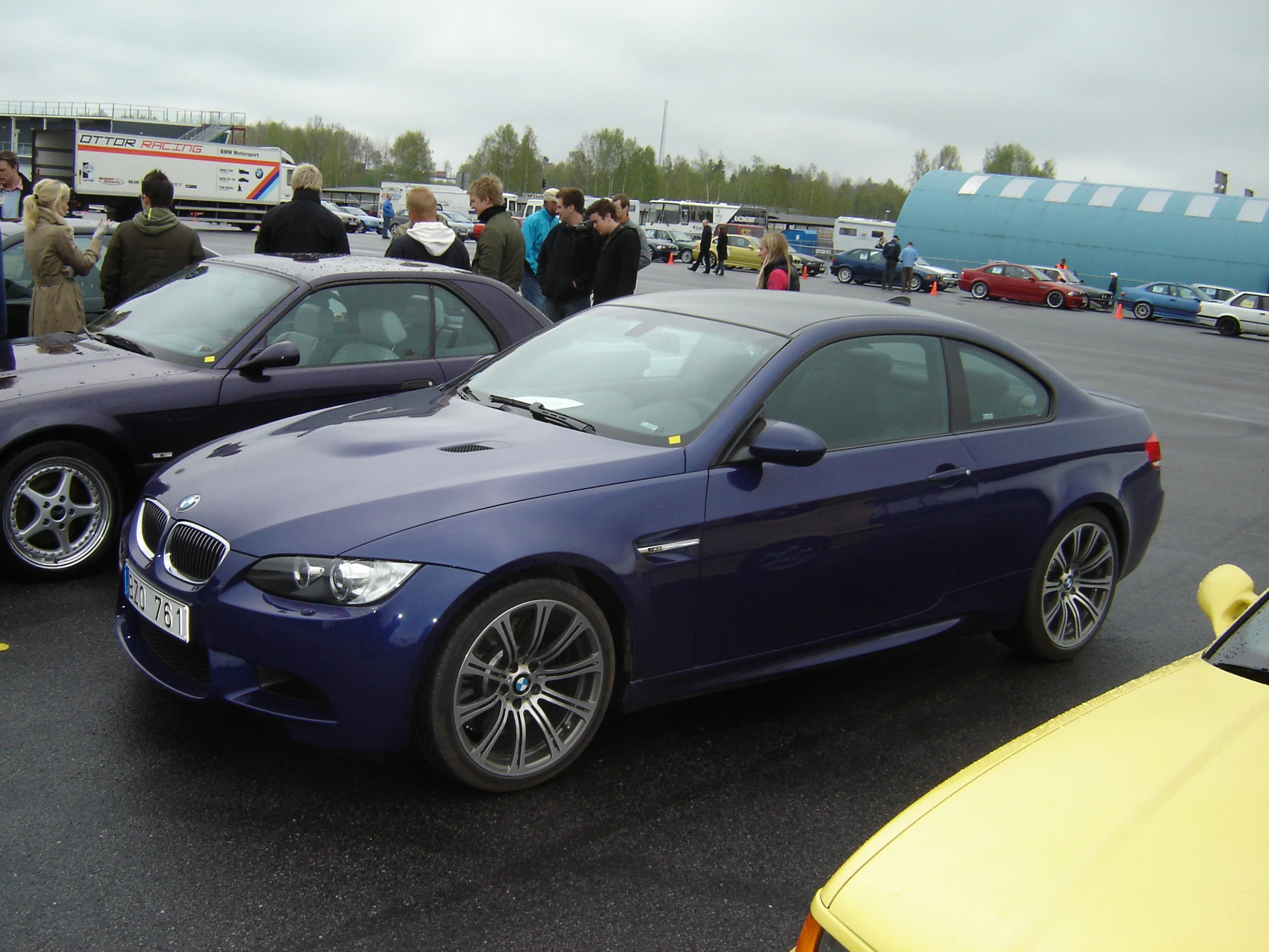 two blue cars parked next to each other