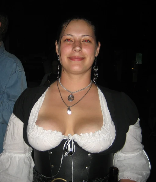 a woman dressed in black and white holding onto a necklace