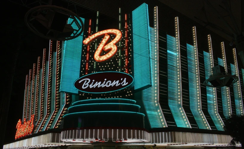 the outside of a building at night with bright lights