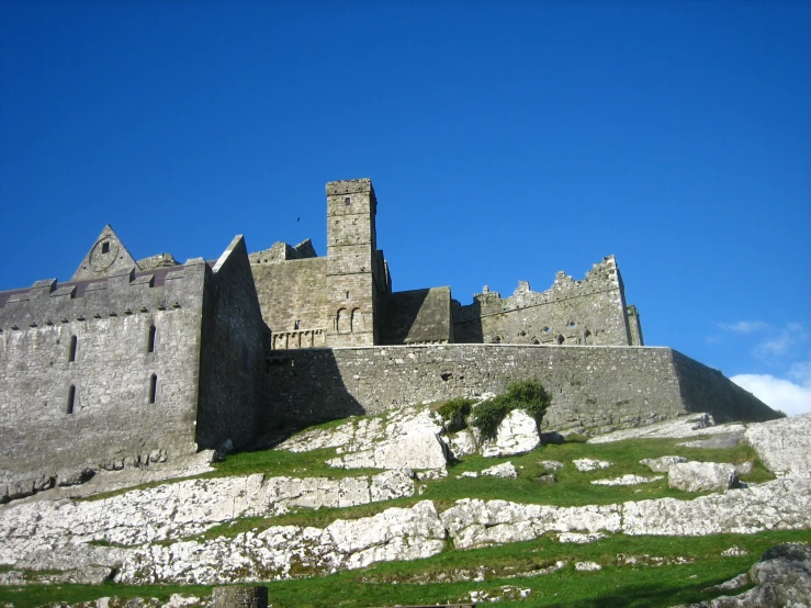 the castle is next to a stone wall