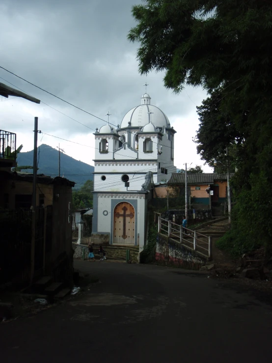 an old church has white paint and is in the village