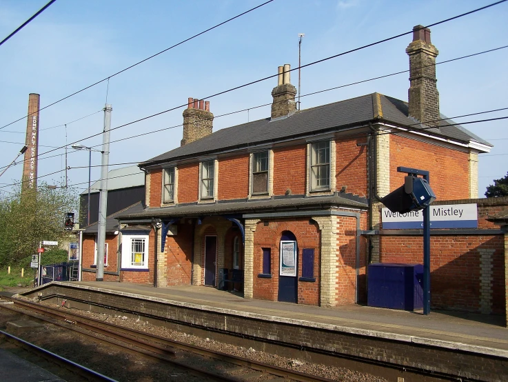 a train station with a train pulling in to the platform