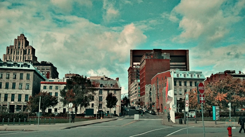 a row of buildings next to the street with a sky background