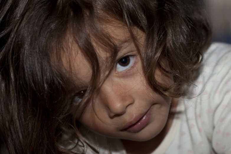 a girl's face is shown against a white background