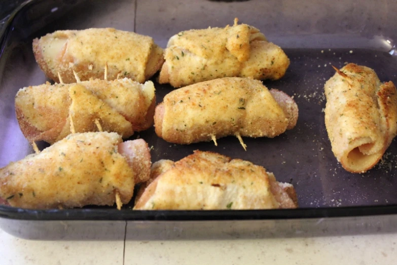 a pan with chicken appetizers sitting on top of it