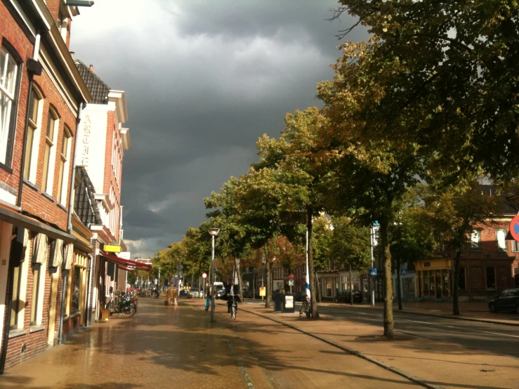 a dark and cloudy sky is seen over an intersection