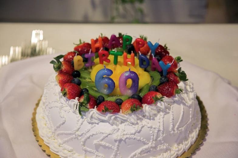 there is a white cake decorated with fruit on it