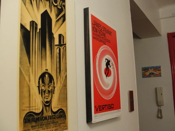a pair of posters hanging on the wall