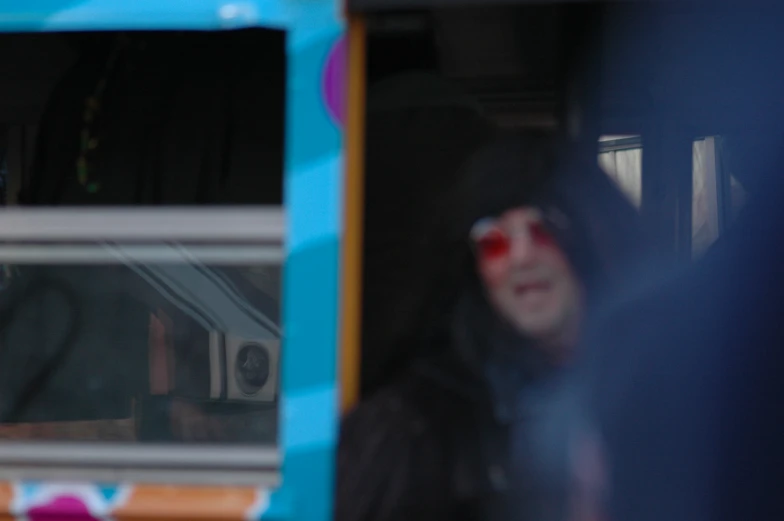 a blurry po of a young woman riding a bus