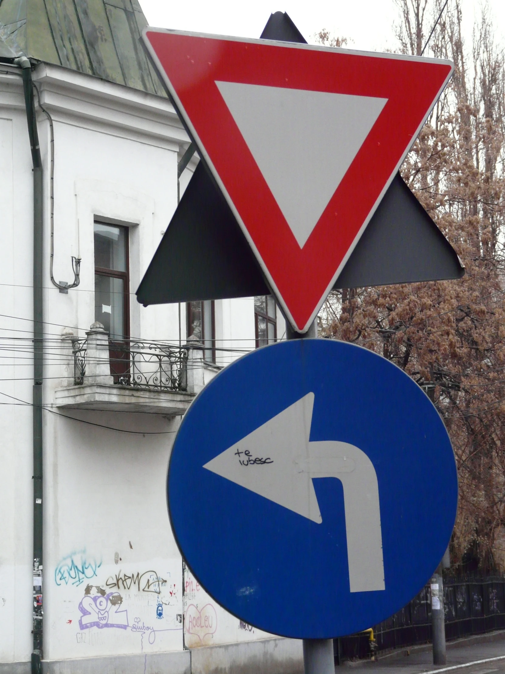 a traffic sign on the corner of a street