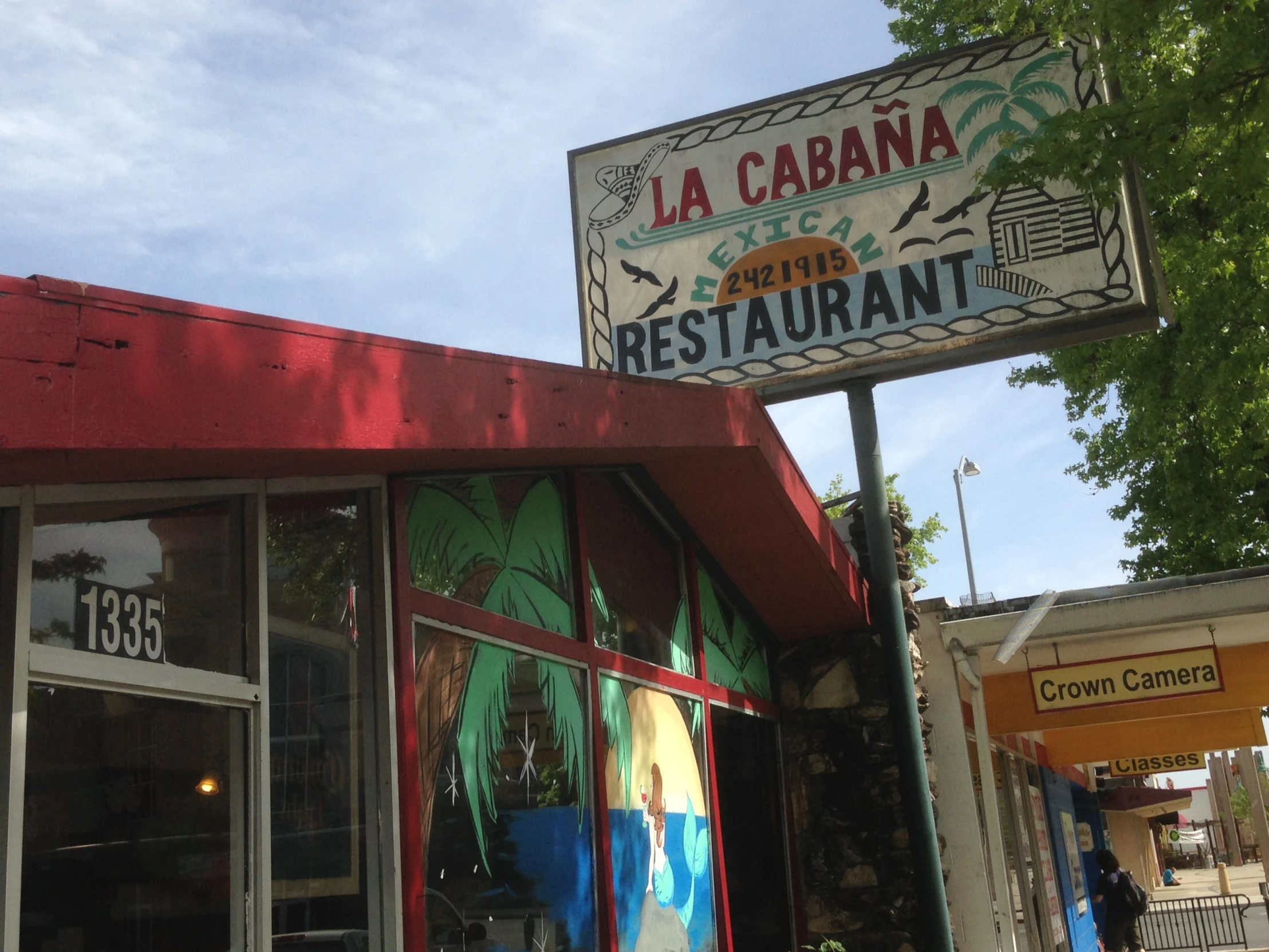 a sign is attached to a restaurant that also has signage