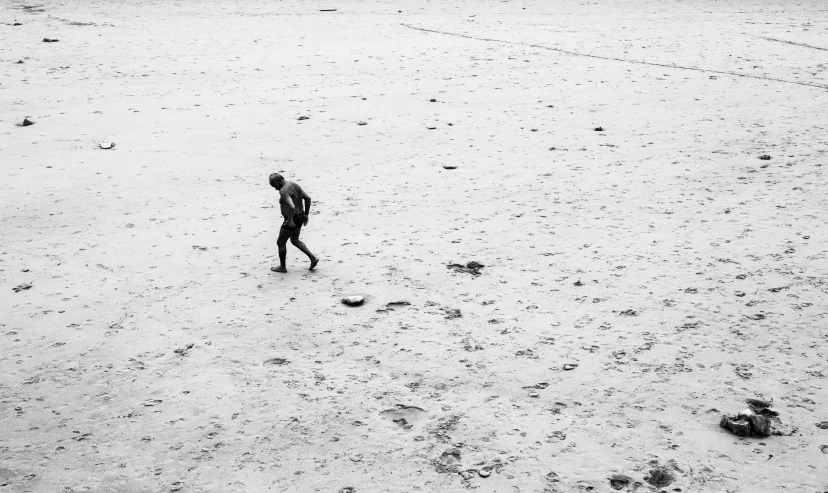 a man in a black wetsuit and a snowboard