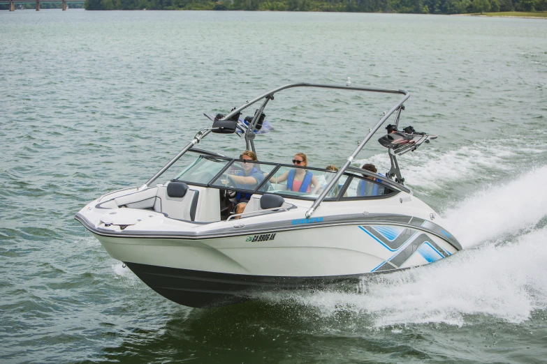 a small motorboat with three people riding it through the water