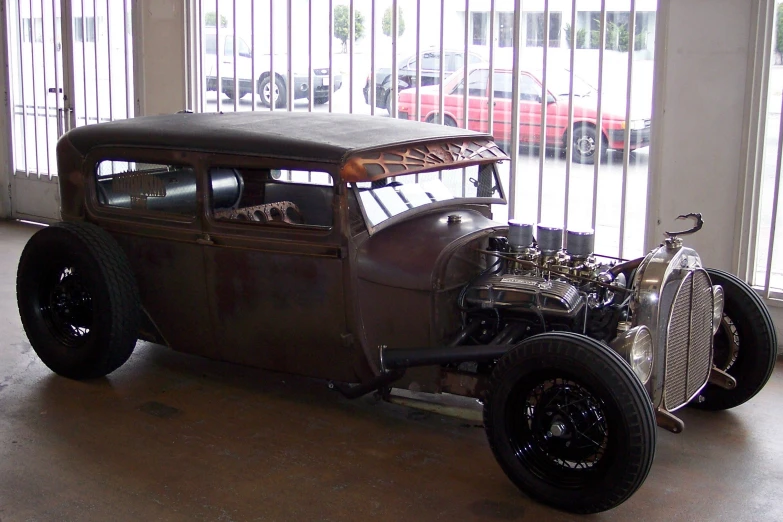 an old time car parked in front of a building