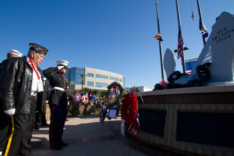 two people in military uniforms at a memorial