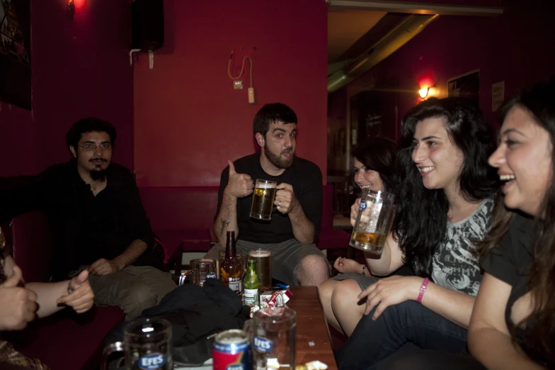a group of people drinking drinks at a restaurant